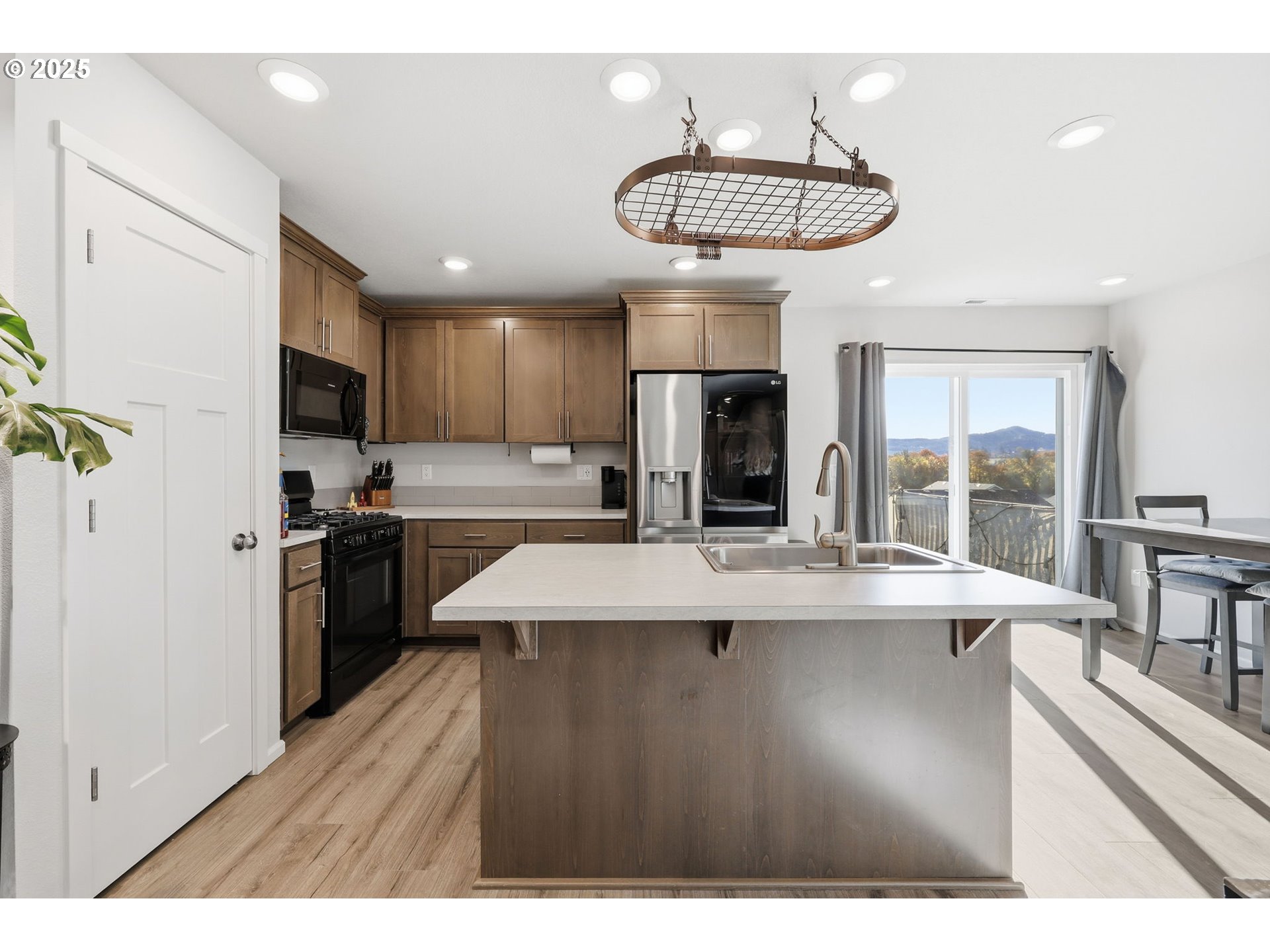 1316 19th Place Forest Grove, OR 97116 - Photo 8 of 36 a kitchen with stainless steel appliances granite countertop a sink a stove and a refrigerator