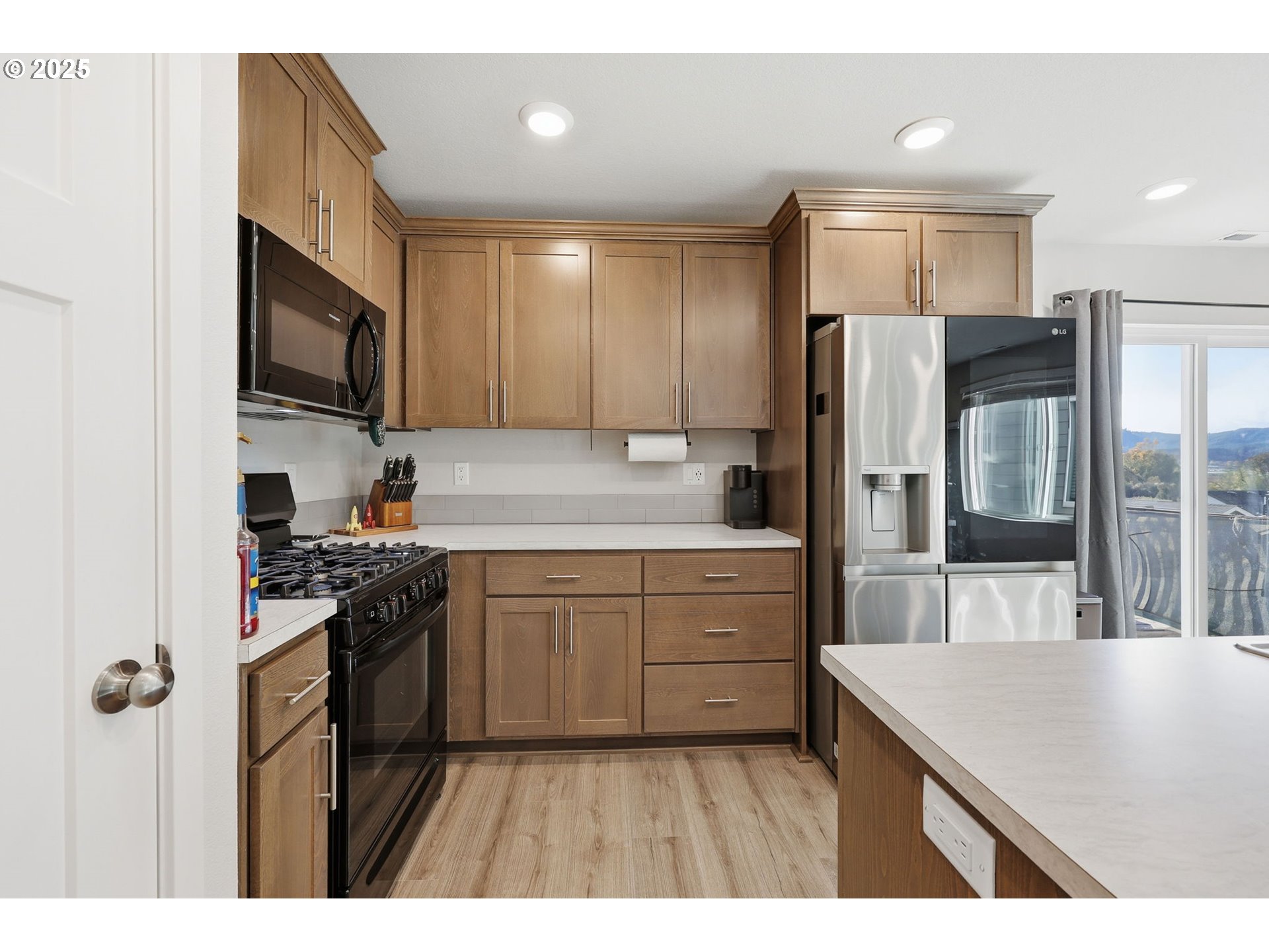 1316 19th Place Forest Grove, OR 97116 - Photo 9 of 36 a kitchen with stainless steel appliances granite countertop a refrigerator stove and sink