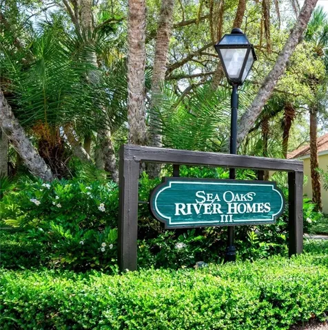 a sign that is sitting on a wooden fence