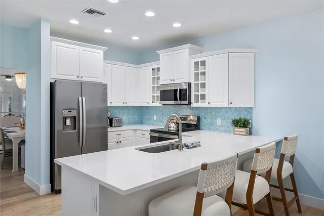 a kitchen with a sink stove and microwave