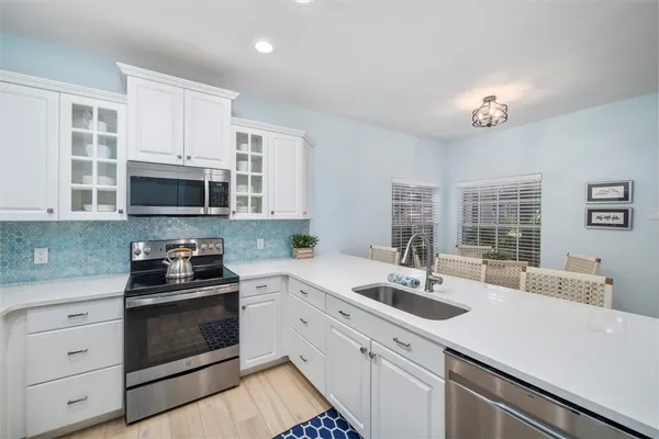 a spacious bathroom with a double vanity sink mirror and a bathtub