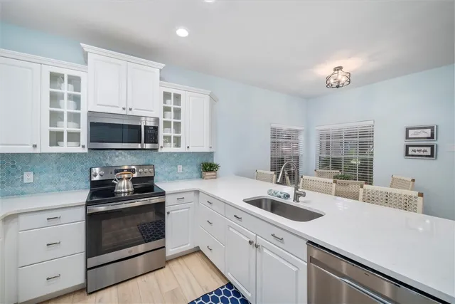 a spacious bathroom with a double vanity sink mirror and a bathtub