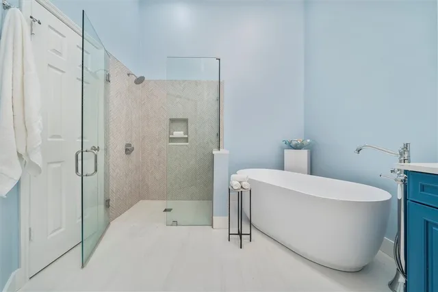 a spacious bathroom with a bathtub and shower