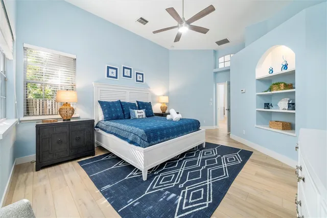 a bedroom with a bed and a chandelier