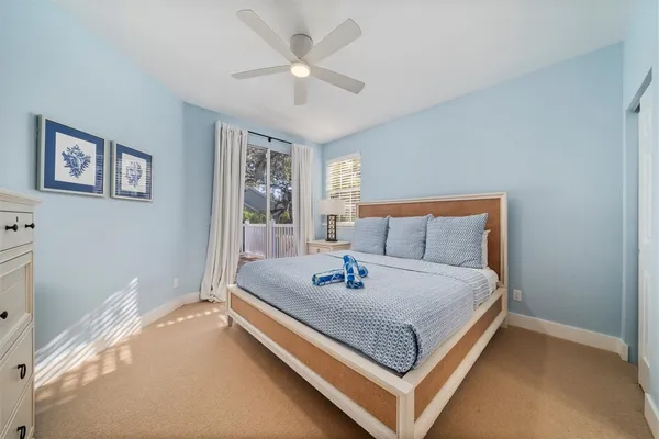 a bedroom with two beds and a window