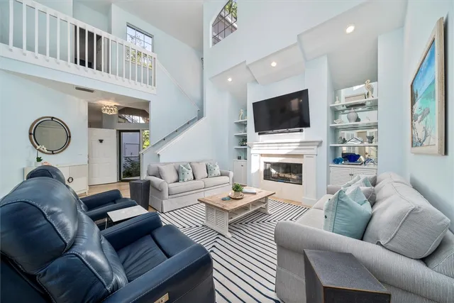 a living room with fireplace furniture and a flat screen tv