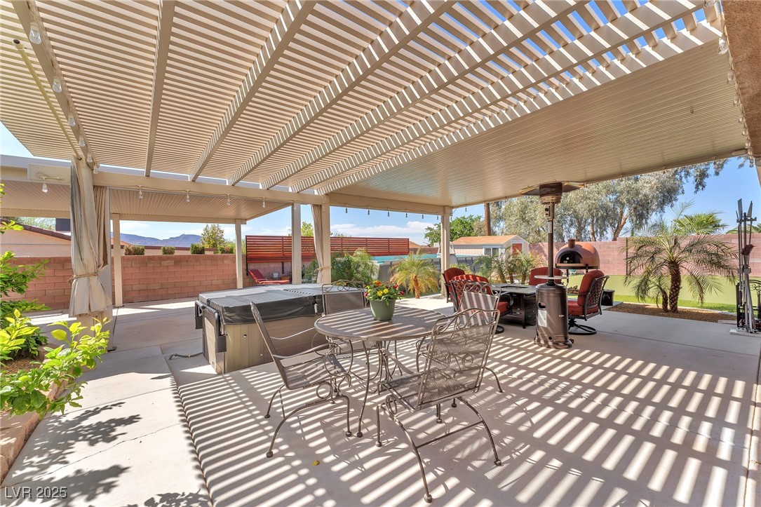 2251 Thoroughbred Road Henderson, NV 89002 - Photo 38 of 60 View of patio with a fenced backyard, a pergola, outdoor dining area, and a hot tub