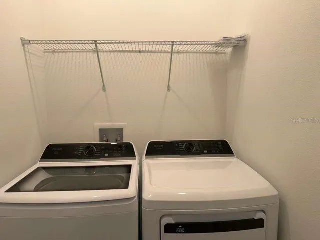 a kitchen with a sink a microwave and refrigerator