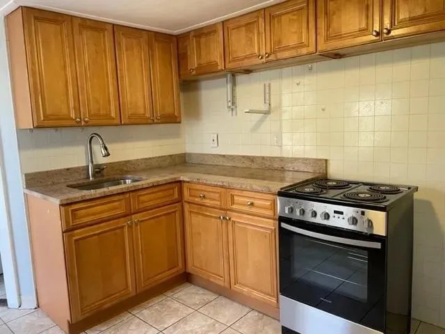 a kitchen with granite countertop cabinets stainless steel appliances and a sink