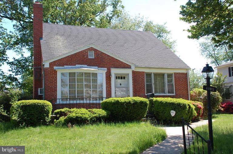 3105 Bonnie Road Baltimore, MD 21209 - Photo 1 of 10 a front view of a house with a garden and yard