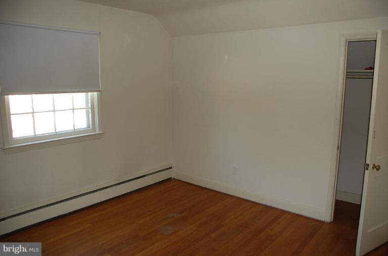 3105 Bonnie Road Baltimore, MD 21209 - Photo 10 of 10 an empty room with wooden floor and windows