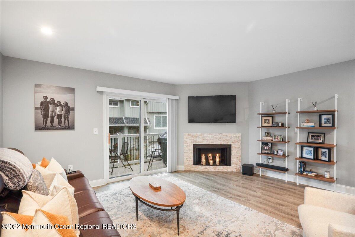 5 Island View Way, Unit 10 Sea Bright, NJ 07760 - Photo 14 of 30 a living room with furniture a flat screen tv and a fireplace
