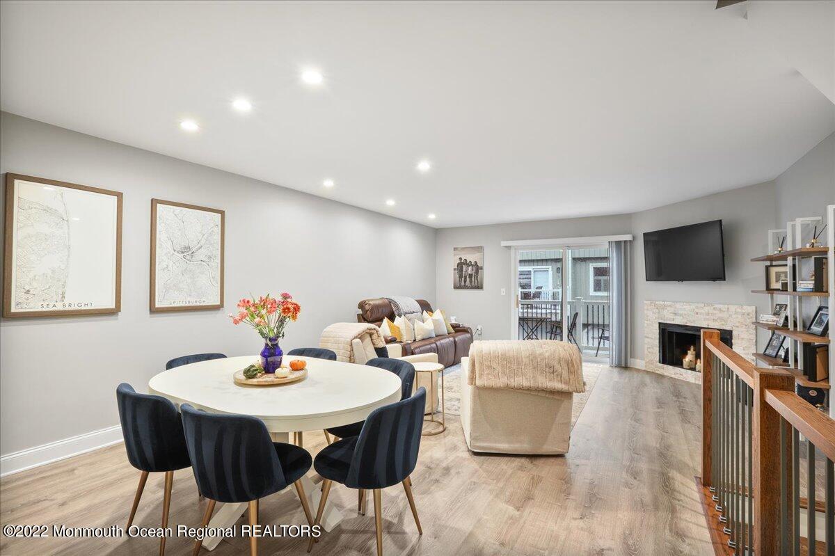 5 Island View Way, Unit 10 Sea Bright, NJ 07760 - Photo 16 of 30 a view of a dining room with furniture and a fireplace