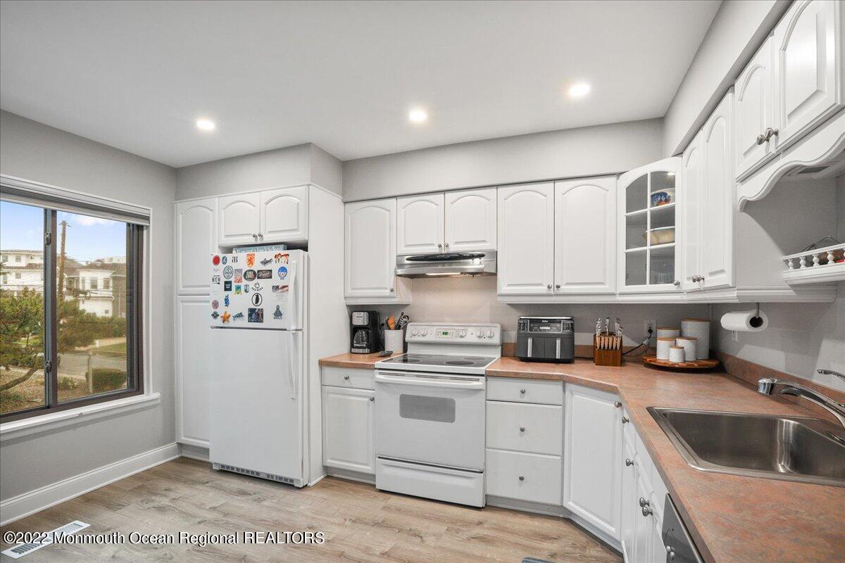 5 Island View Way, Unit 10 Sea Bright, NJ 07760 - Photo 20 of 30 a kitchen with cabinets and window