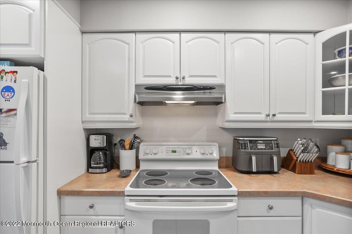 5 Island View Way, Unit 10 Sea Bright, NJ 07760 - Photo 22 of 30 a white stove top oven sitting inside of a kitchen