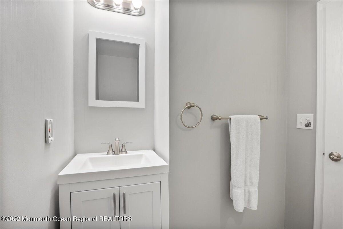 5 Island View Way, Unit 10 Sea Bright, NJ 07760 - Photo 24 of 30 a bathroom with a sink and mirror