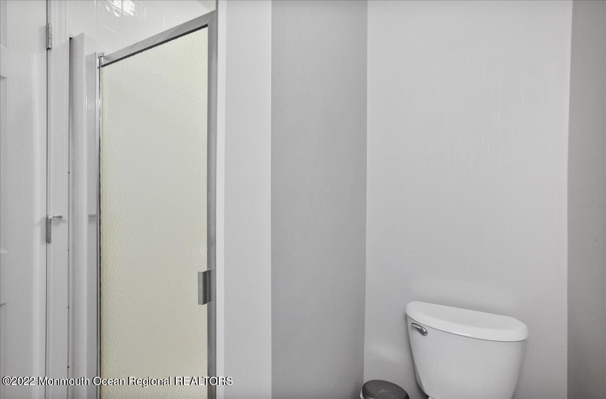5 Island View Way, Unit 10 Sea Bright, NJ 07760 - Photo 25 of 30 a white toilet sitting next to a shower