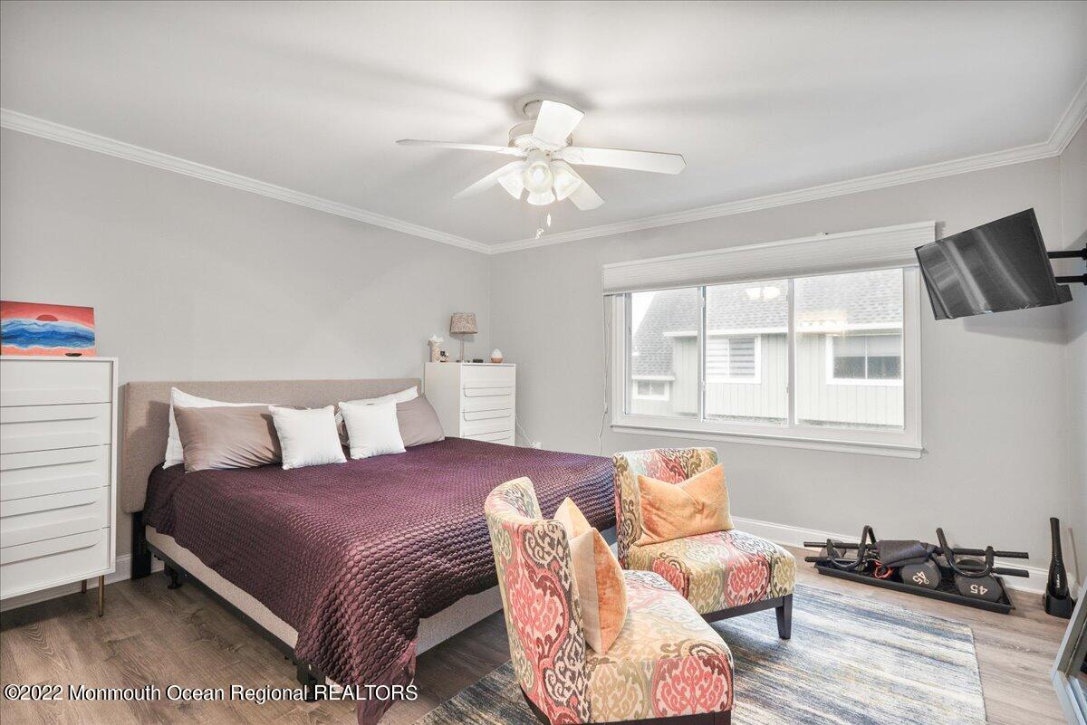 5 Island View Way, Unit 10 Sea Bright, NJ 07760 - Photo 27 of 30 a bedroom with a bed and wooden floor