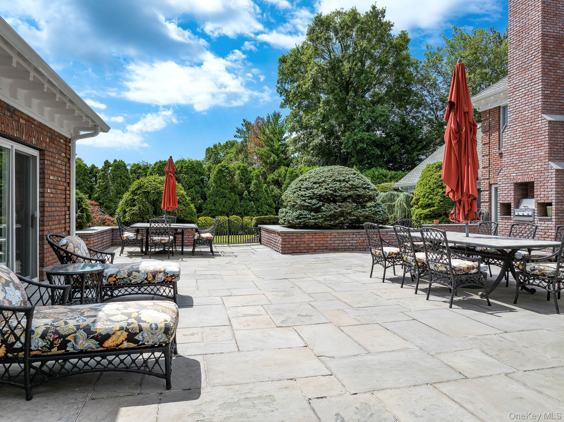 109 Mamaroneck Road Scarsdale, NY 10583 - Photo 16 of 50 View of courtyard patio from pool area, with outdoor lounging, dining and grilling area