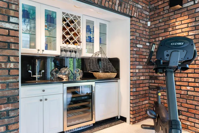a kitchen with kitchen island granite countertop wooden cabinets and dining table