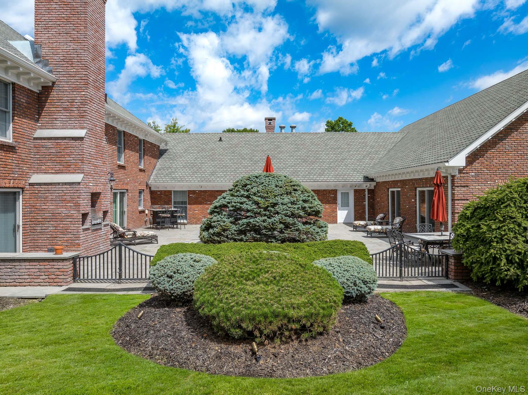 109 Mamaroneck Road Scarsdale, NY 10583 - Photo 18 of 50 View of courtyard patio from property with specimen plantings, brink planters, custom gates, built in outdoor kitchen