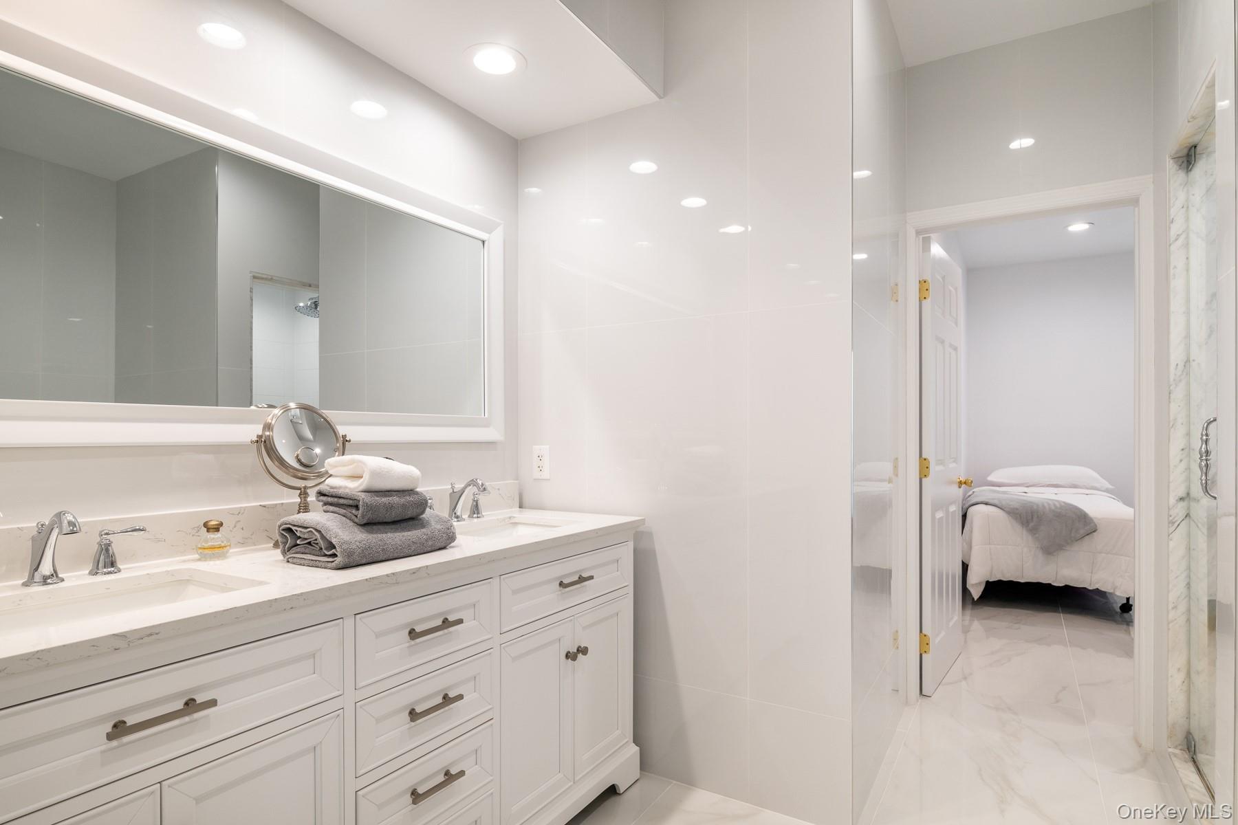 109 Mamaroneck Road Scarsdale, NY 10583 - Photo 20 of 50 Newly renovated full bathroom with another shower by pool, courtyard and spa with double vanity, recessed lighting, new like-marble floors.