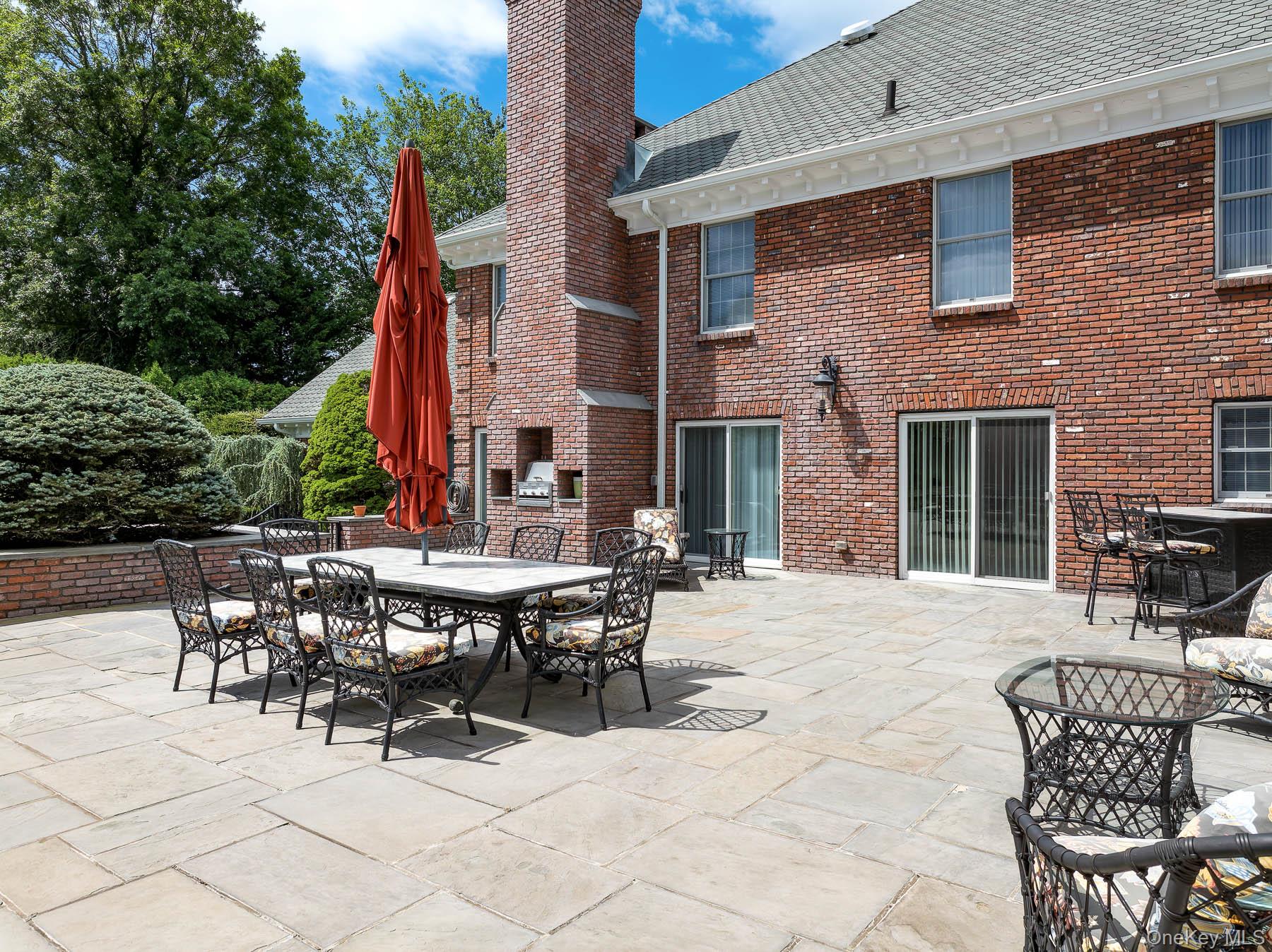 109 Mamaroneck Road Scarsdale, NY 10583 - Photo 25 of 50 View of courtyard patio featuring outdoor lounging, dining, entertaining with built-in gas grill, sliding glass doors to kitchen and fireside lounge
