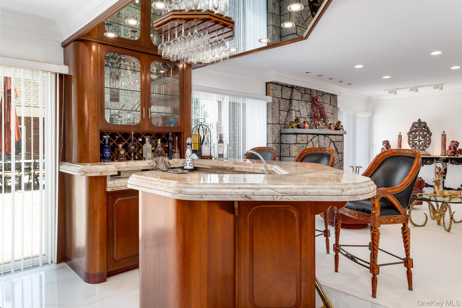 109 Mamaroneck Road Scarsdale, NY 10583 - Photo 29 of 50 Cocktail bar to showcase your private collections with recessed lighting, thick granite counters, plenty of natural light with glass sliders to courtyard, a stone fireside lounge with recessed lighting