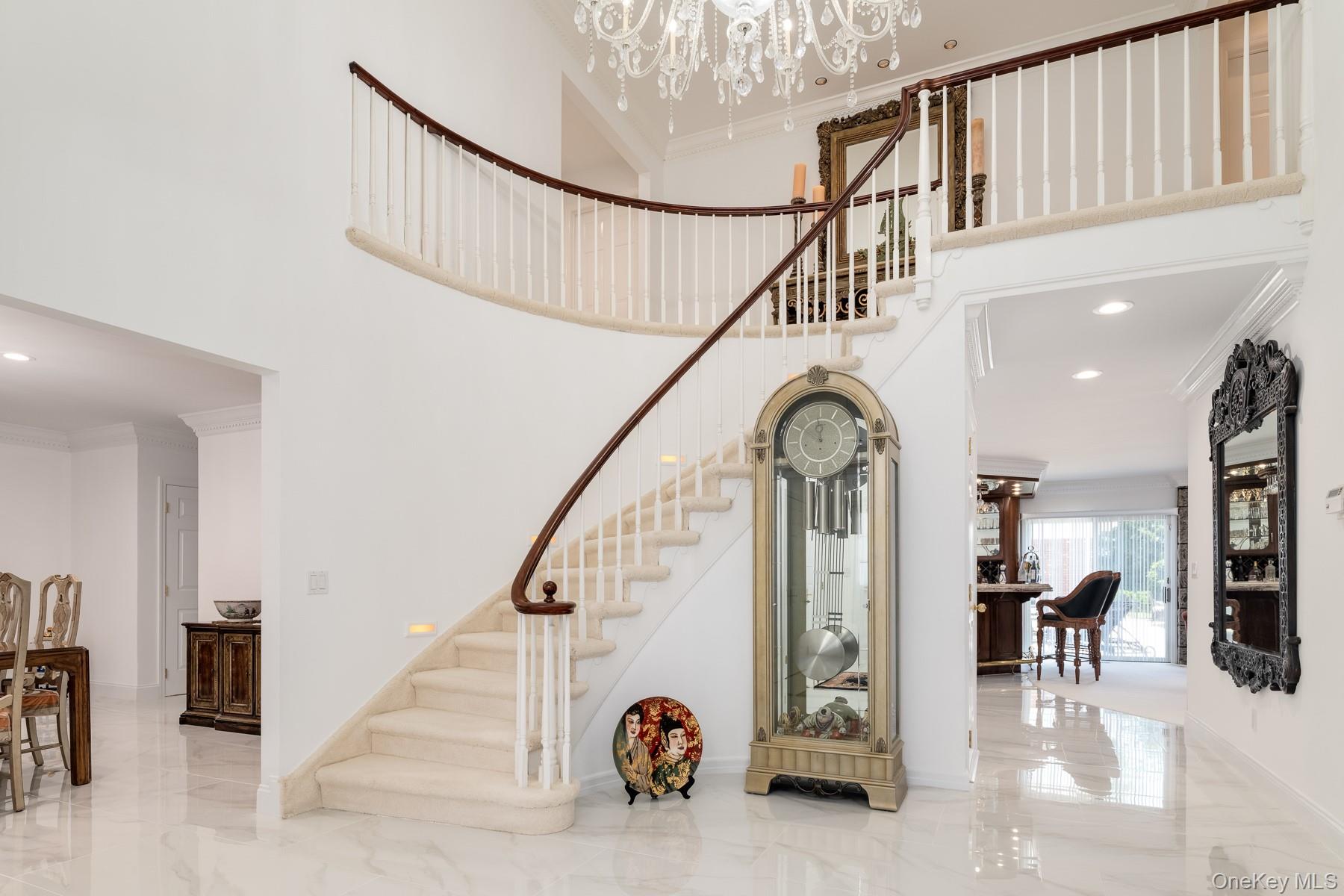 109 Mamaroneck Road Scarsdale, NY 10583 - Photo 32 of 50 Grand two-story entry with sweeping staircas, Greek dentil molding, recessed lighting, two Strauss & Swarvorski crystal chandeliers and new like-marble tiled flooring