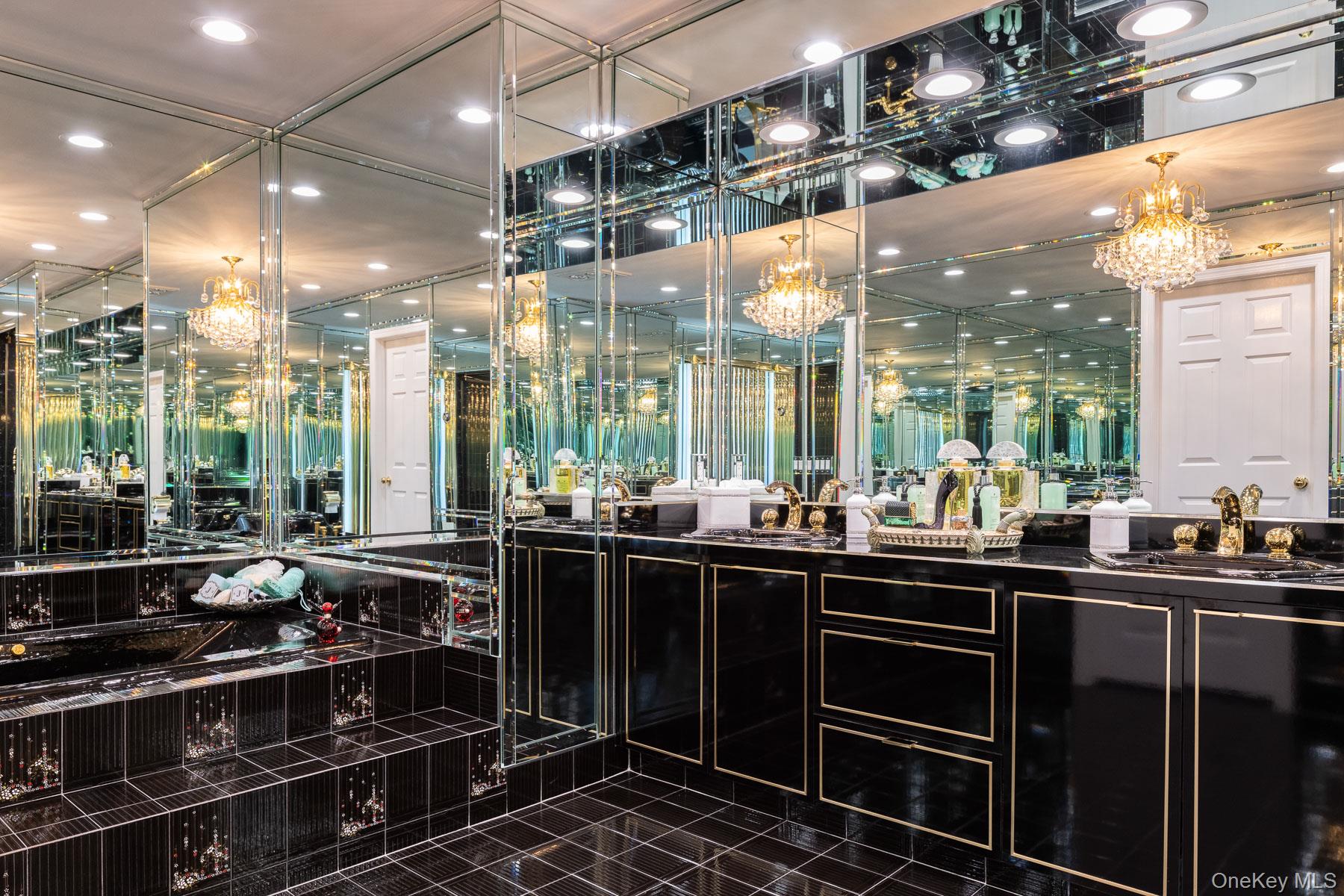 109 Mamaroneck Road Scarsdale, NY 10583 - Photo 41 of 50 Primary bathroom featuring spa tub, steam shower, bidet, chandelier, exquisite black tile and flooring, recessed lighting on dimmers, and double vanity with cast iron sinks