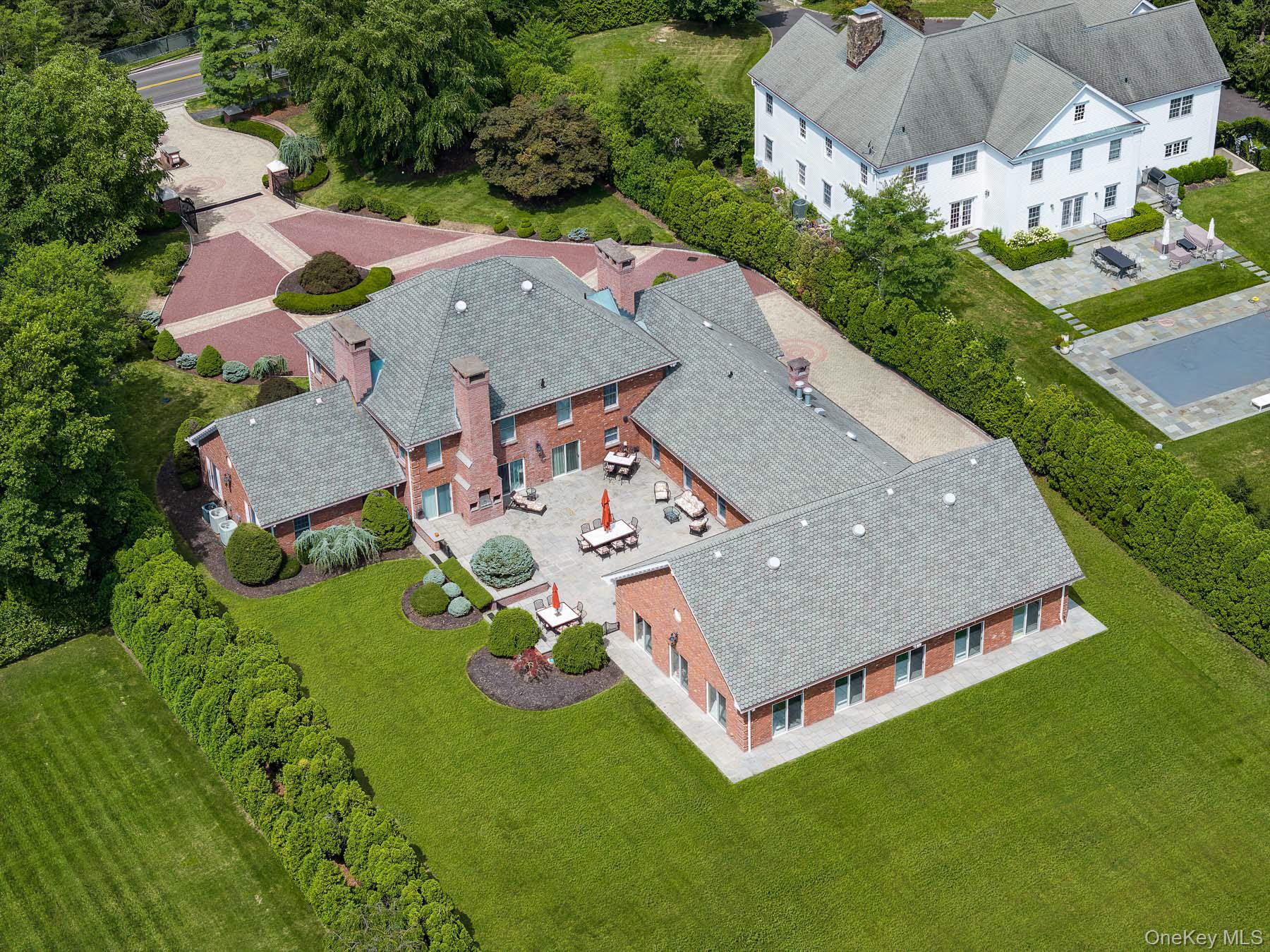 109 Mamaroneck Road Scarsdale, NY 10583 - Photo 8 of 50 Ariel view of indoor heated pool room, sliders accessing property and courtyard with built-in gas grill and sliders to kitchen