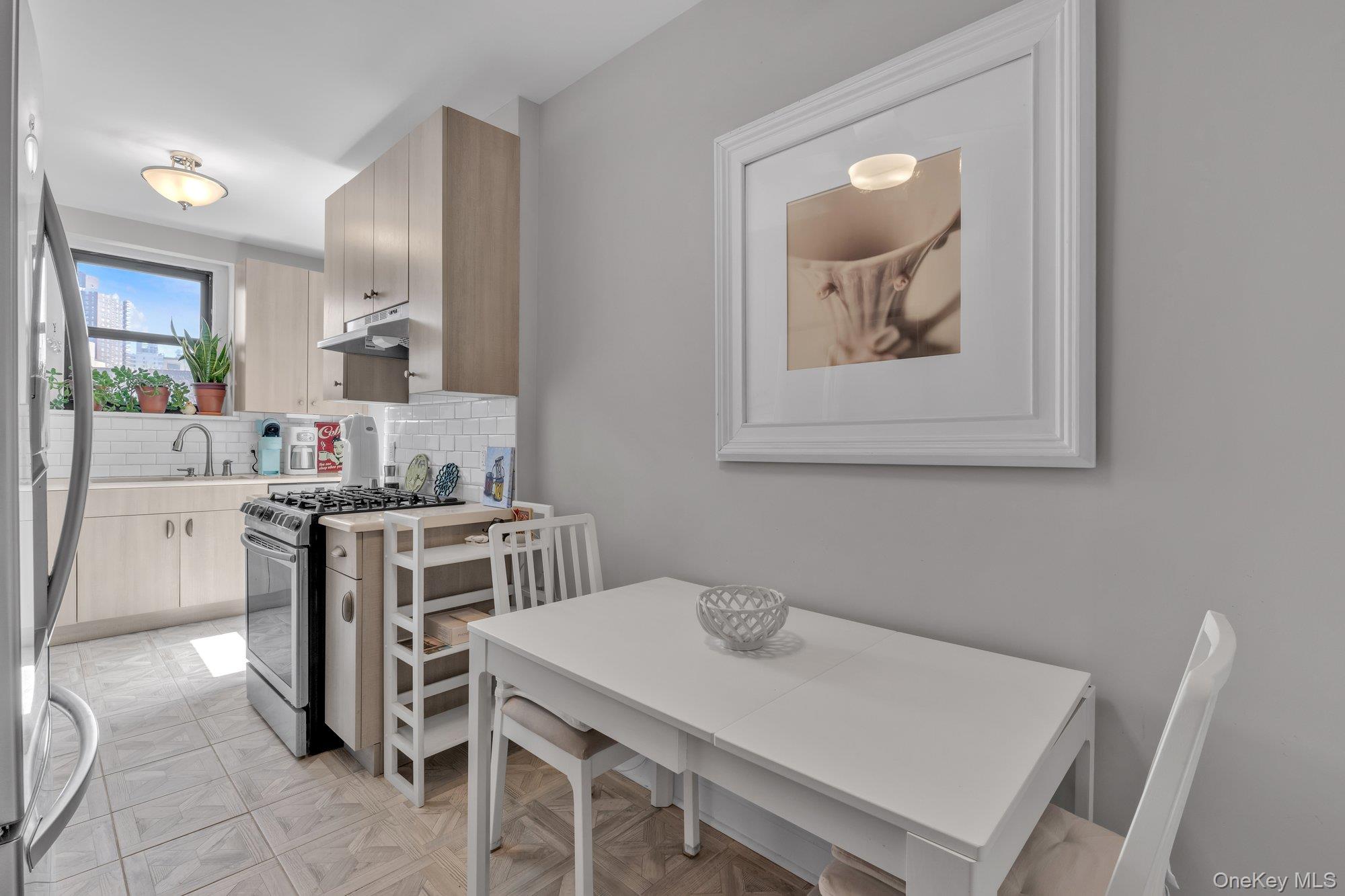 84-51 Beverly Road, Unit 6A Queens, NY 11415 - Photo 7 of 14 a view of a dining room with furniture and wooden floor