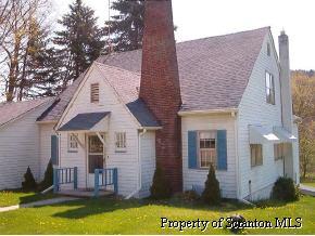 a view of house with a yard