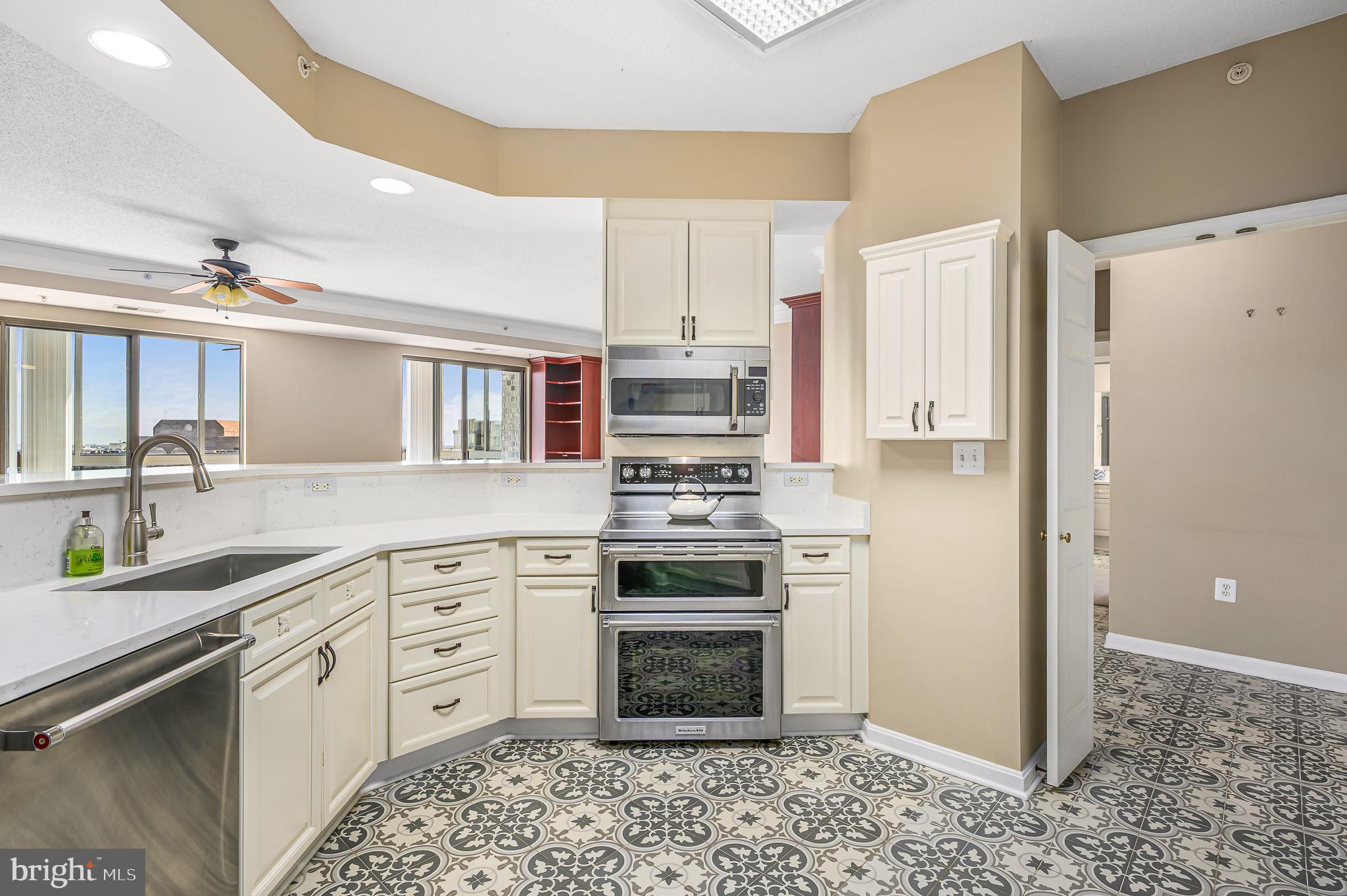19365 Cypress Ridge Terrace, Unit 1115 Leesburg, VA 20176 - Photo 10 of 34 a kitchen with stainless steel appliances granite countertop a stove a sink and a refrigerator