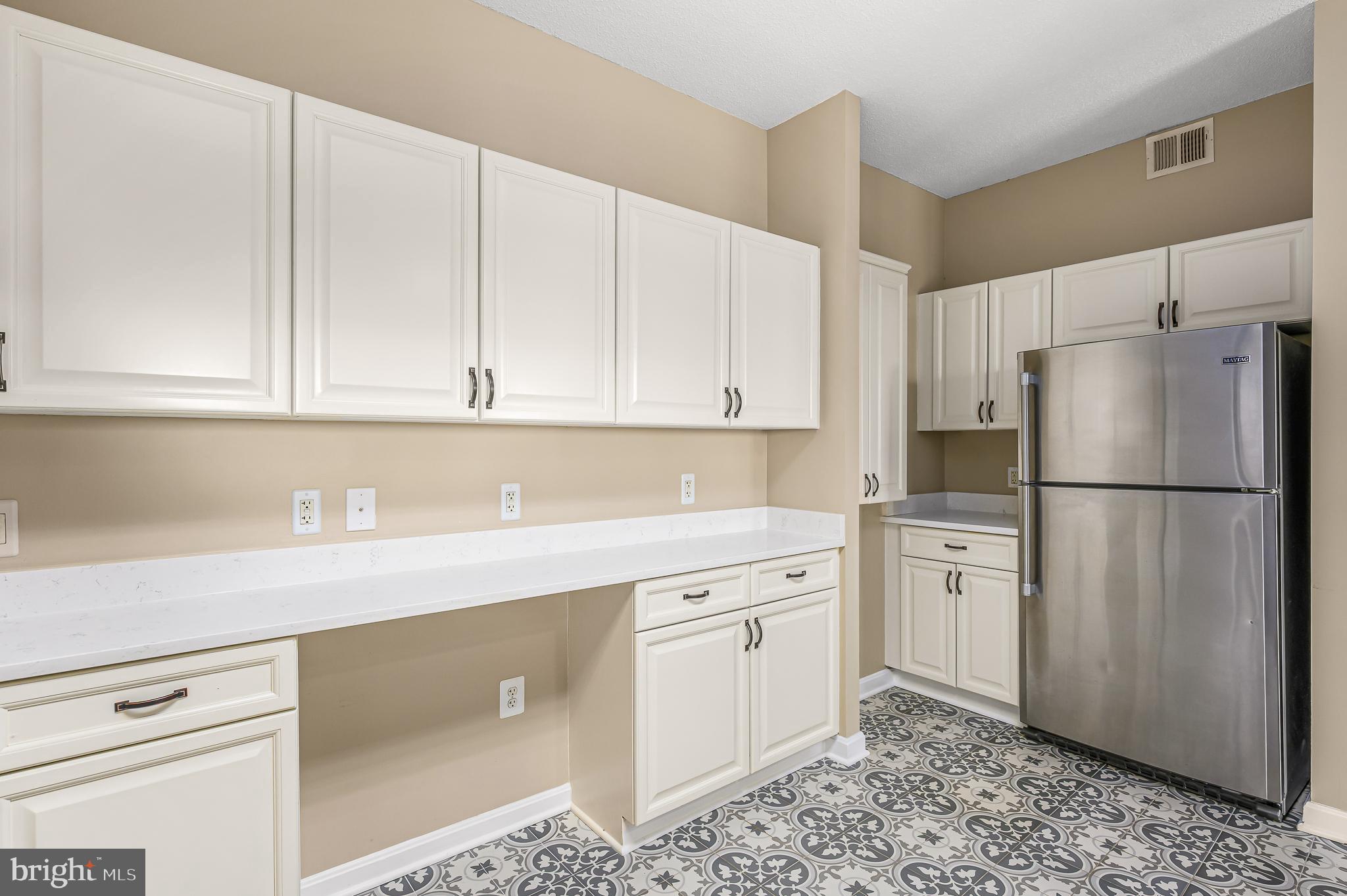 19365 Cypress Ridge Terrace, Unit 1115 Leesburg, VA 20176 - Photo 11 of 34 a kitchen with appliances cabinets and a counter top space