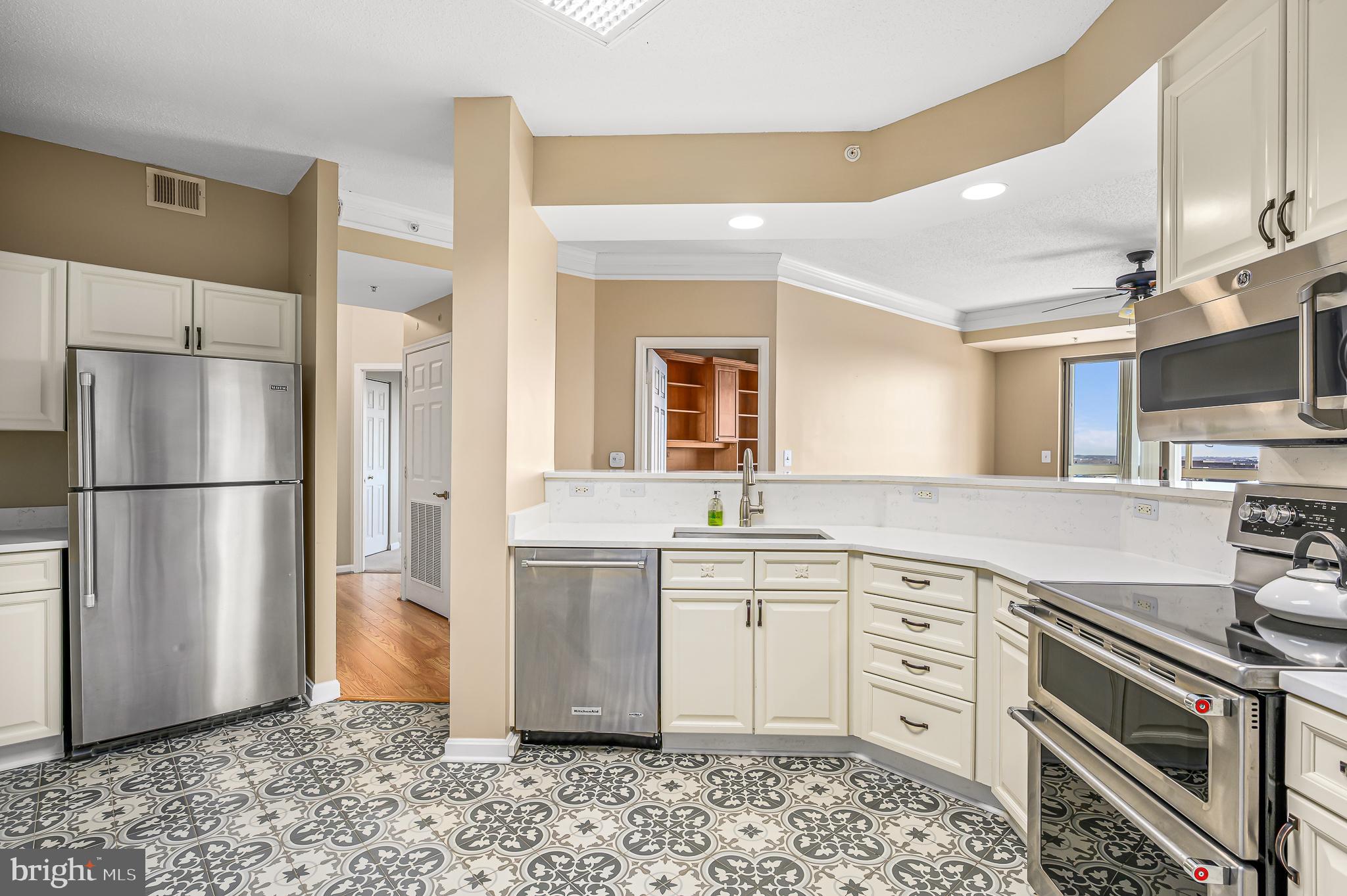 19365 Cypress Ridge Terrace, Unit 1115 Leesburg, VA 20176 - Photo 12 of 34 a kitchen with stainless steel appliances a refrigerator sink and microwave