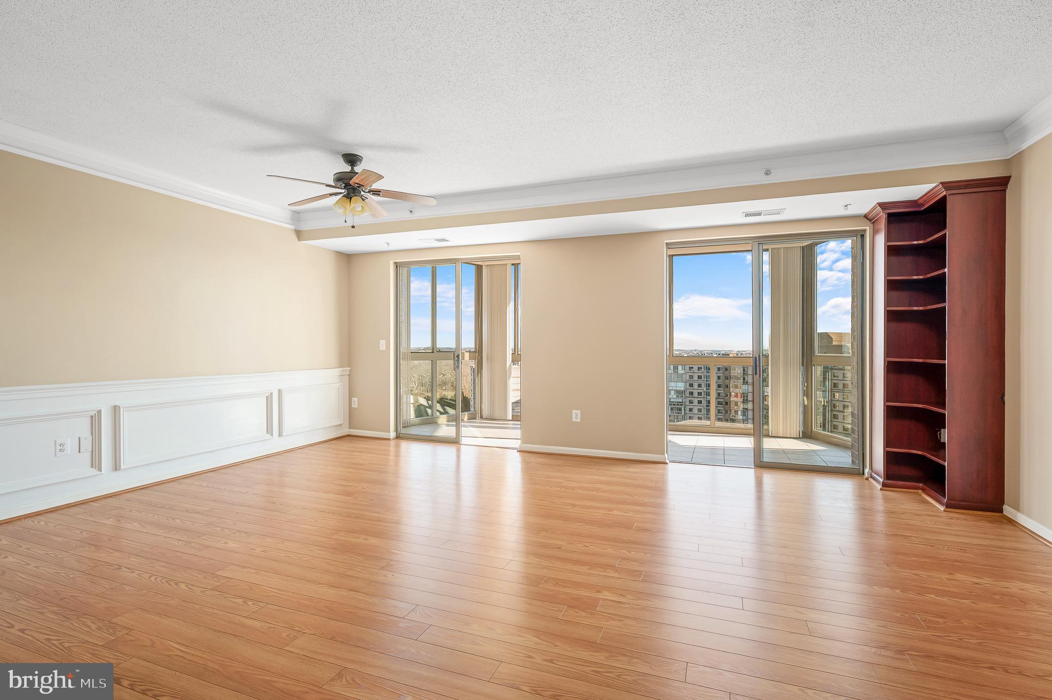 19365 Cypress Ridge Terrace, Unit 1115 Leesburg, VA 20176 - Photo 2 of 34 a view of an empty room with a window and wooden floor