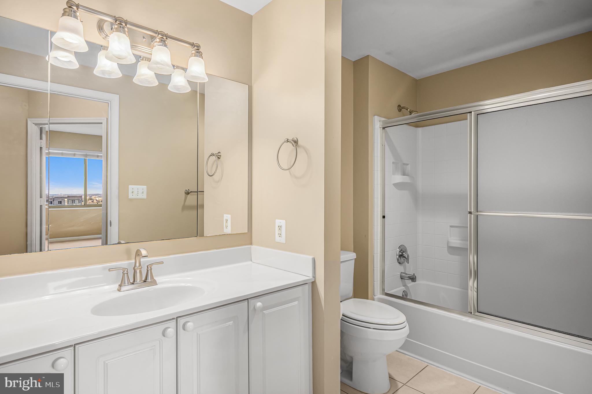 19365 Cypress Ridge Terrace, Unit 1115 Leesburg, VA 20176 - Photo 23 of 34 a bathroom with a sink a toilet and shower