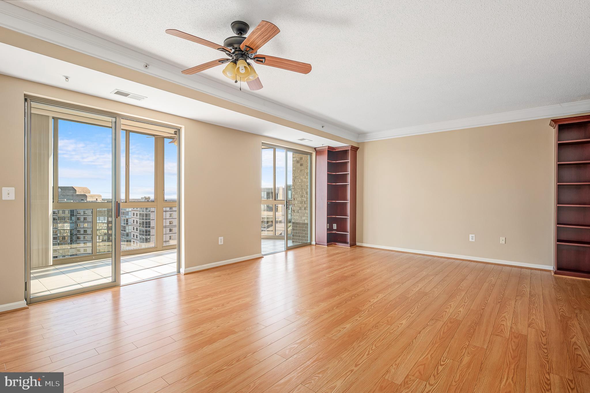 19365 Cypress Ridge Terrace, Unit 1115 Leesburg, VA 20176 - Photo 3 of 34 a view of an empty room with a window and wooden floor