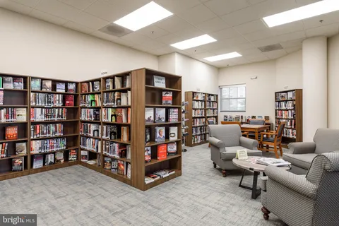 a living room with lots of furniture and a book shelf