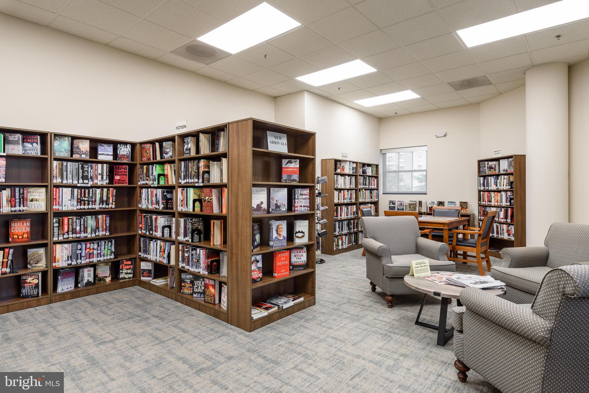 19365 Cypress Ridge Terrace, Unit 1115 Leesburg, VA 20176 - Photo 31 of 34 a living room with lots of furniture and a book shelf