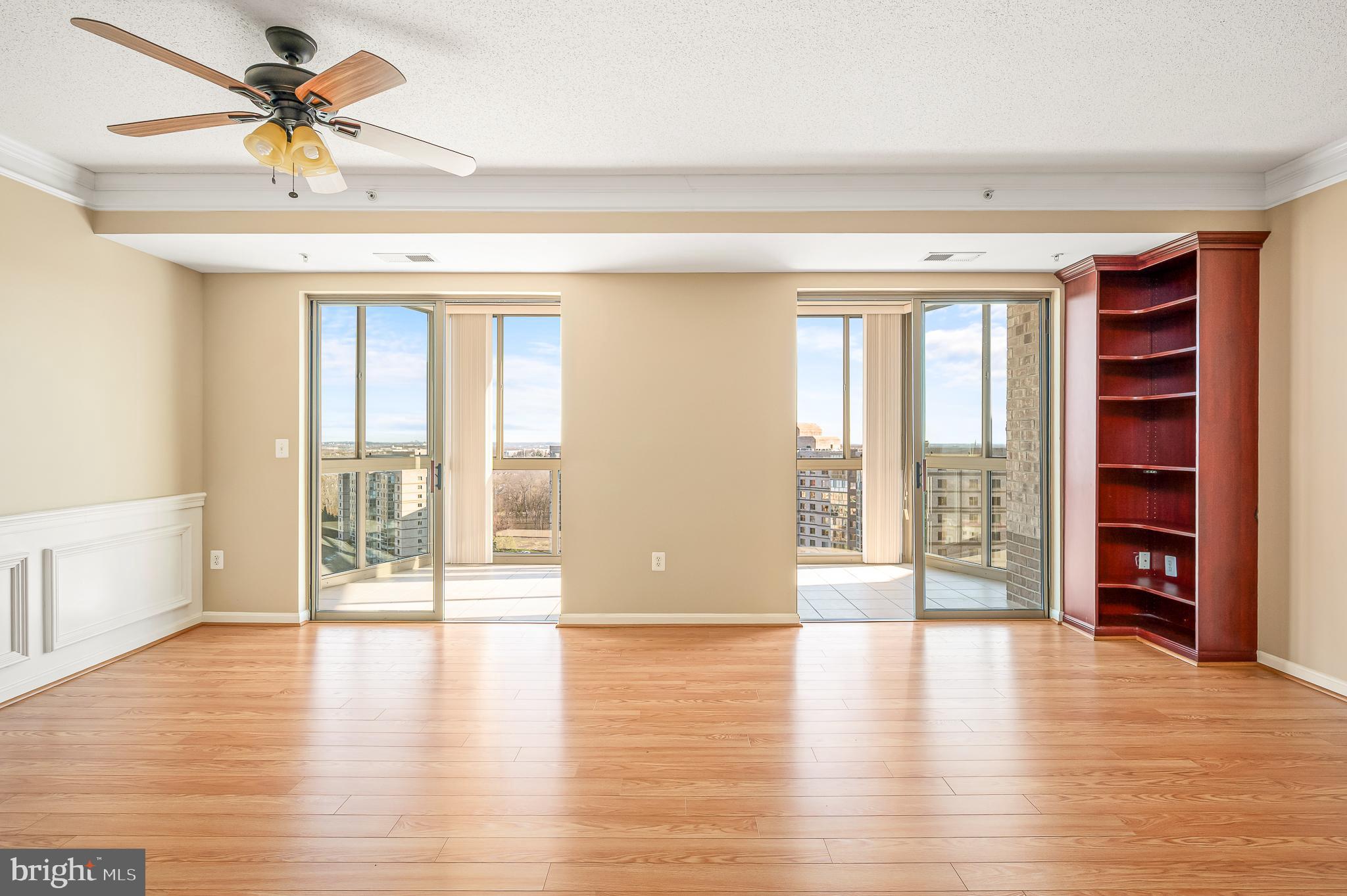 19365 Cypress Ridge Terrace, Unit 1115 Leesburg, VA 20176 - Photo 6 of 34 a view of an empty room with a window and wooden floor