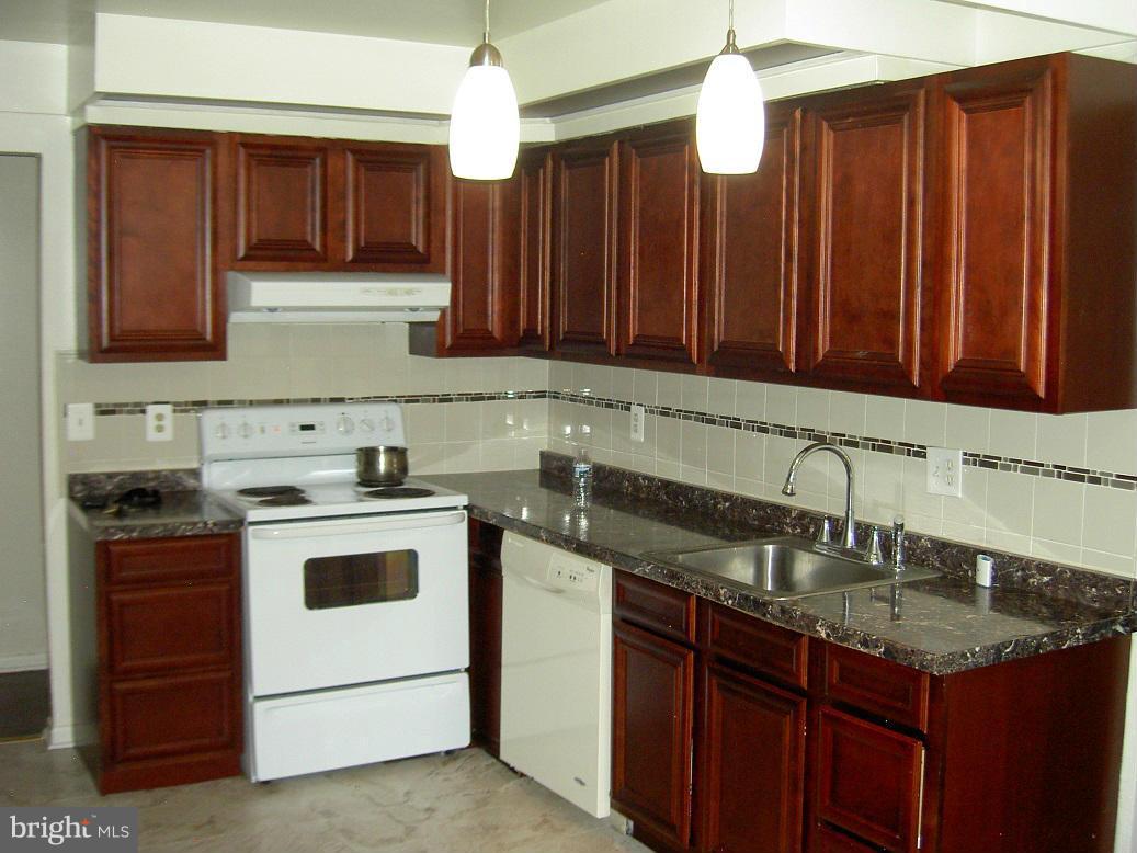 4510 Maryknoll Road Baltimore, MD 21208 - Photo 12 of 30 a kitchen with stainless steel appliances granite countertop a sink stove and refrigerator