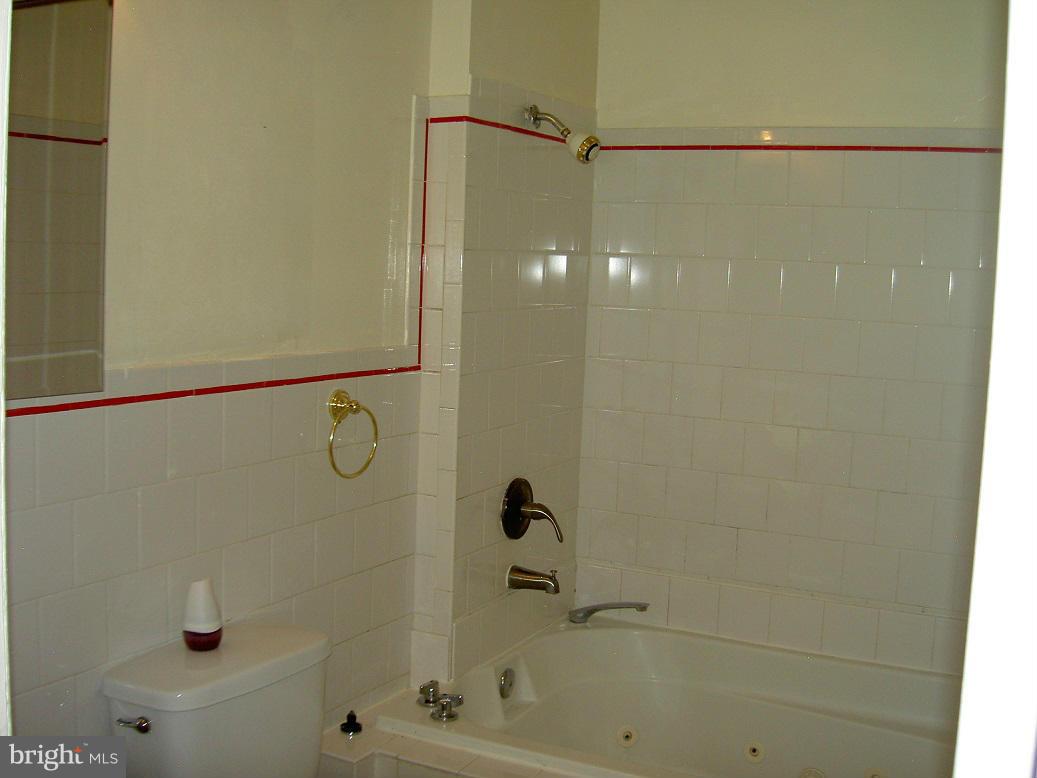 4510 Maryknoll Road Baltimore, MD 21208 - Photo 19 of 30 a bathroom with a bathtub and a shower