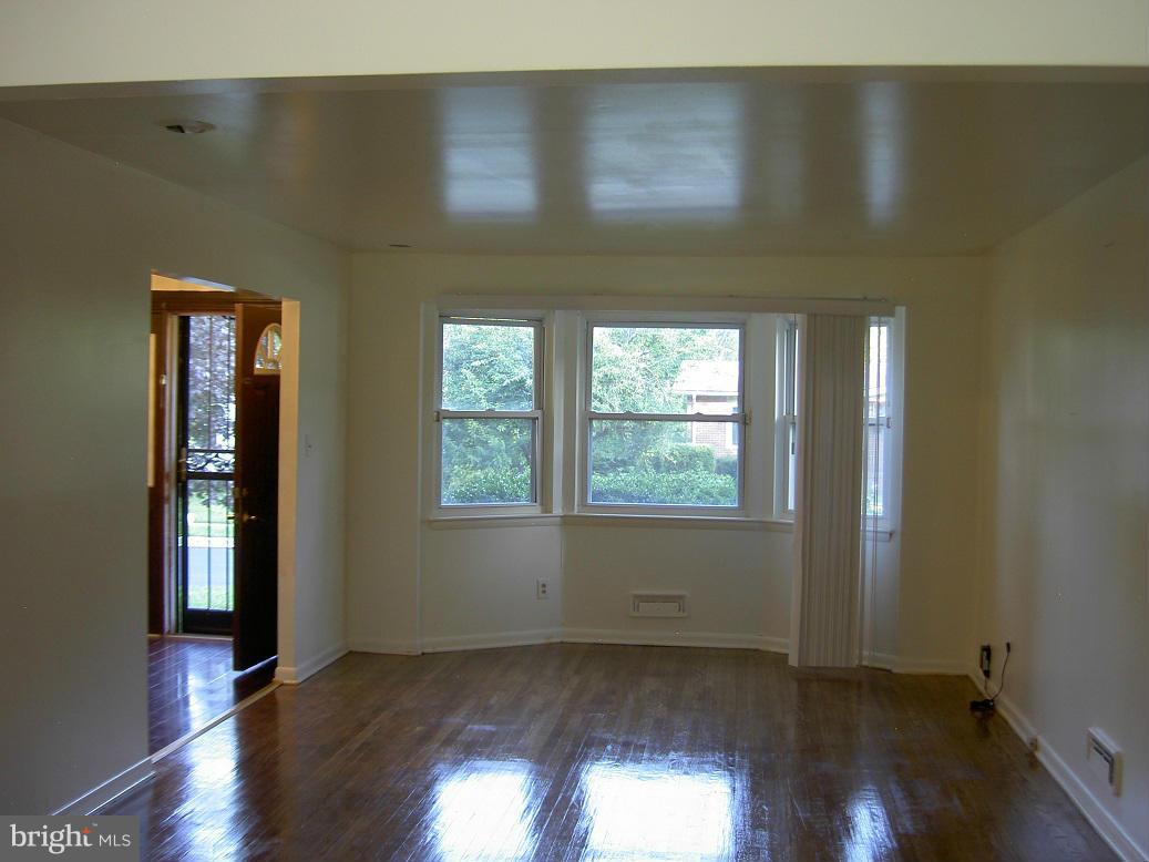 4510 Maryknoll Road Baltimore, MD 21208 - Photo 8 of 30 an empty room with wooden floor and windows
