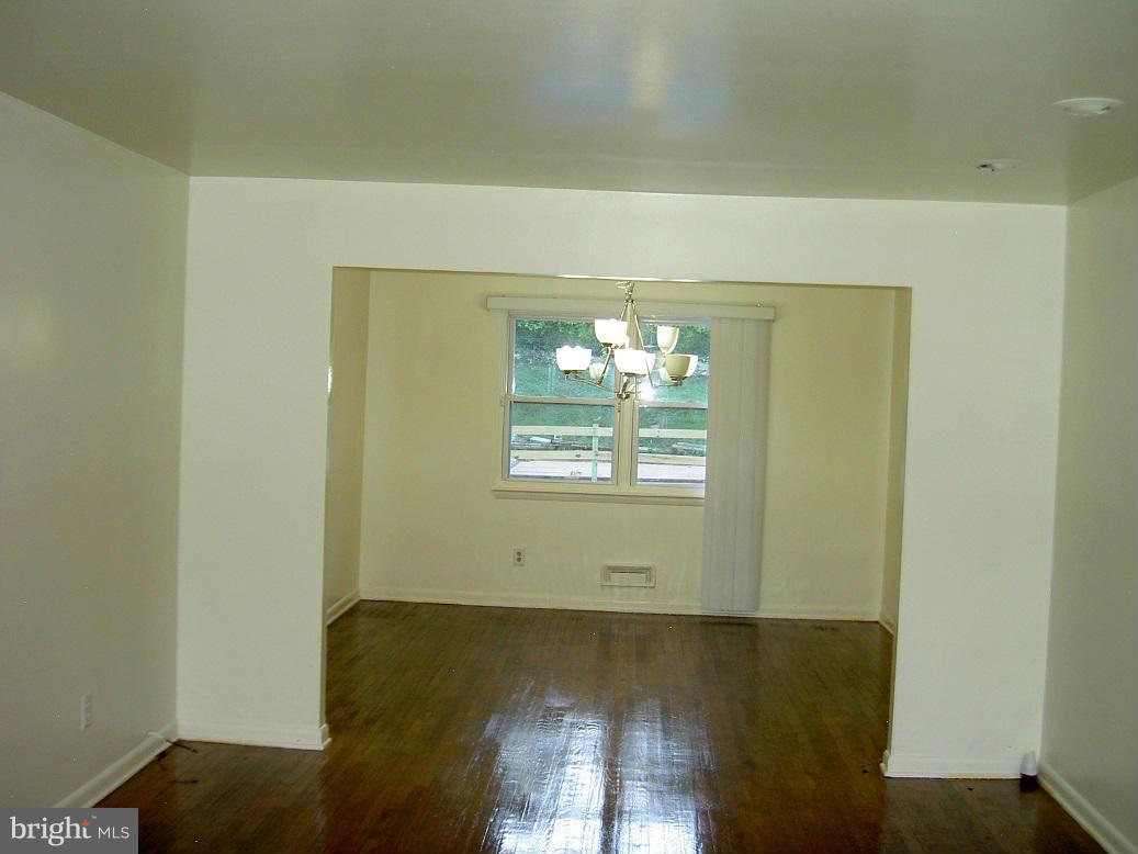 4510 Maryknoll Road Baltimore, MD 21208 - Photo 9 of 30 a view of a room with wooden floor and a ceiling fan