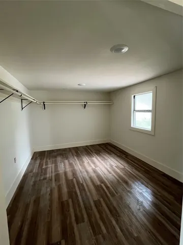 a view of an empty room and wooden floor