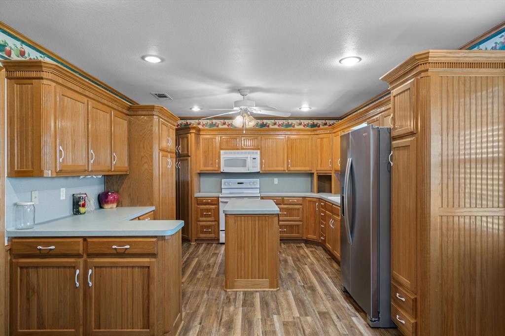 3121 County Road 1215 Canton, TX 75103 - Photo 14 of 40 a kitchen with a refrigerator and a sink