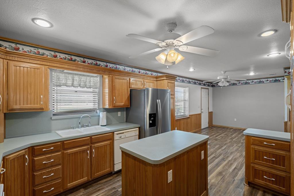 3121 County Road 1215 Canton, TX 75103 - Photo 17 of 40 a kitchen with a stove a sink dishwasher and a refrigerator