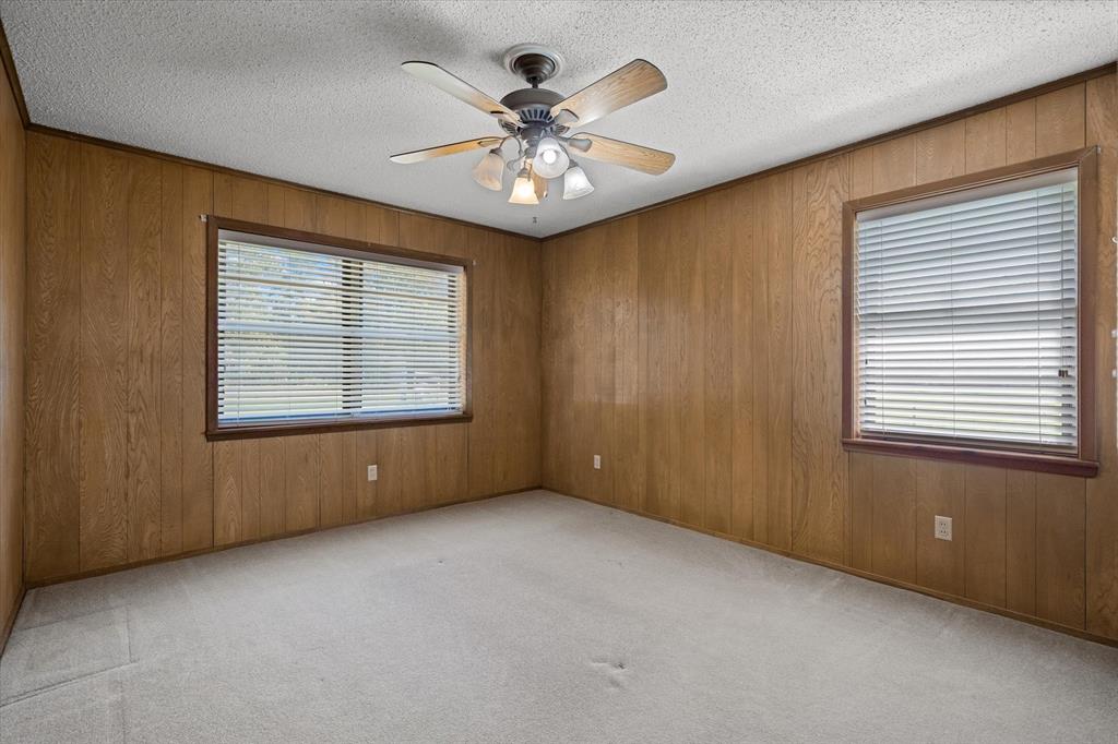 3121 County Road 1215 Canton, TX 75103 - Photo 24 of 40 an empty room with chandelier fan and windows